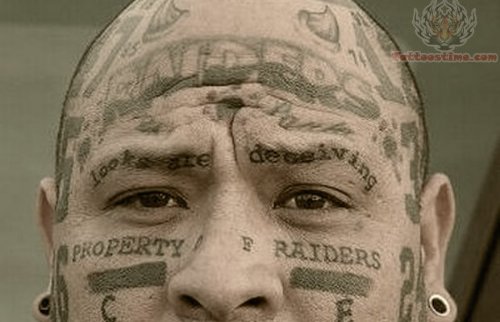 Raiders Grey Ink Tattoo On Face